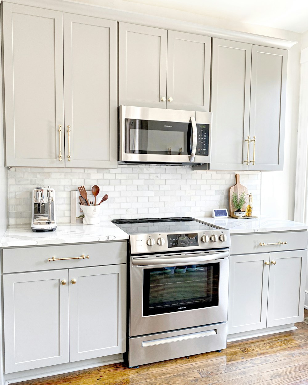 white microwave oven on white wooden cabinet