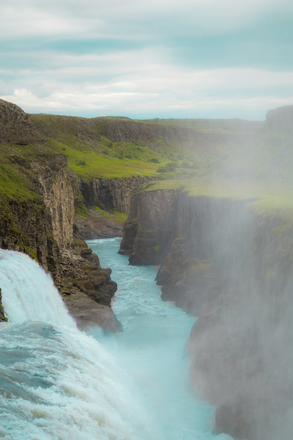 waterfalls on green and brown mountain during daytime