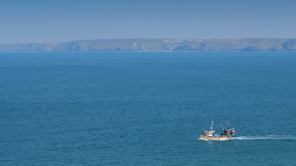 white boat on blue sea during daytime