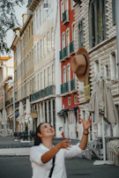 A candid expression of joy during a street performance, framed by striking urban architecture.