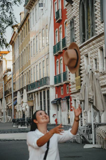 A candid expression of joy during a street performance, framed by striking urban architecture.
