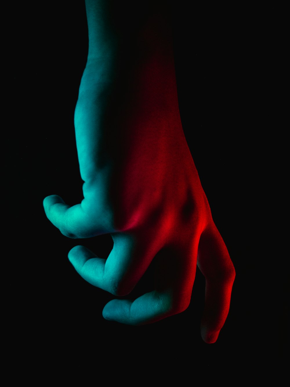 persons hand with red heart