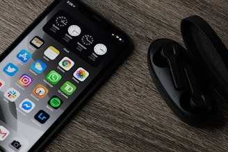 black iphone 5 on brown wooden table