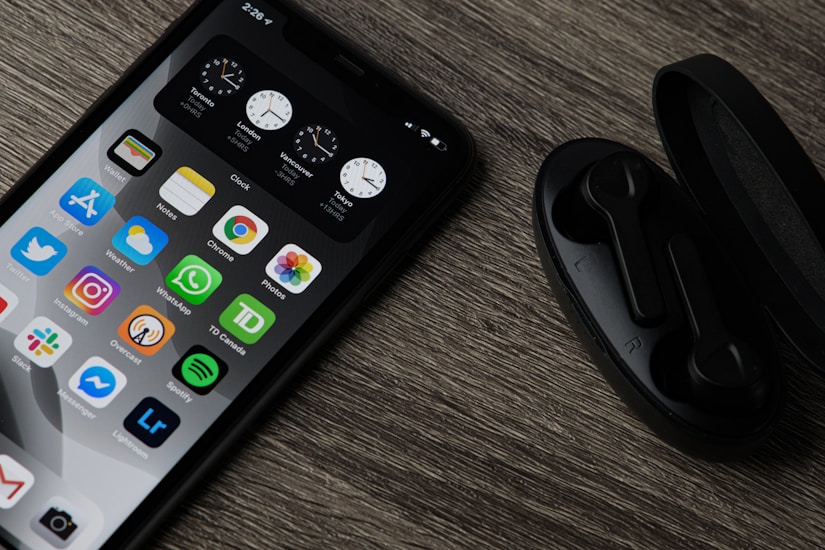 black iphone 5 on brown wooden table