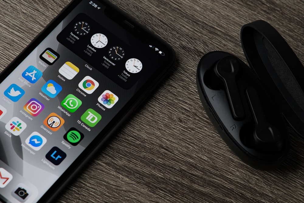 black iphone 5 on brown wooden table