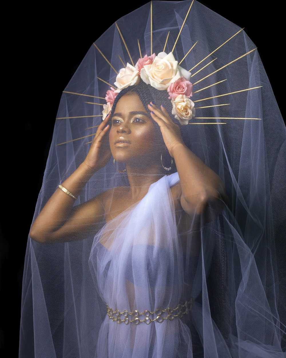 woman in white wedding dress covering her face with white mesh veil