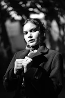 Elegant black and white portrait of a person in thoughtful pose.