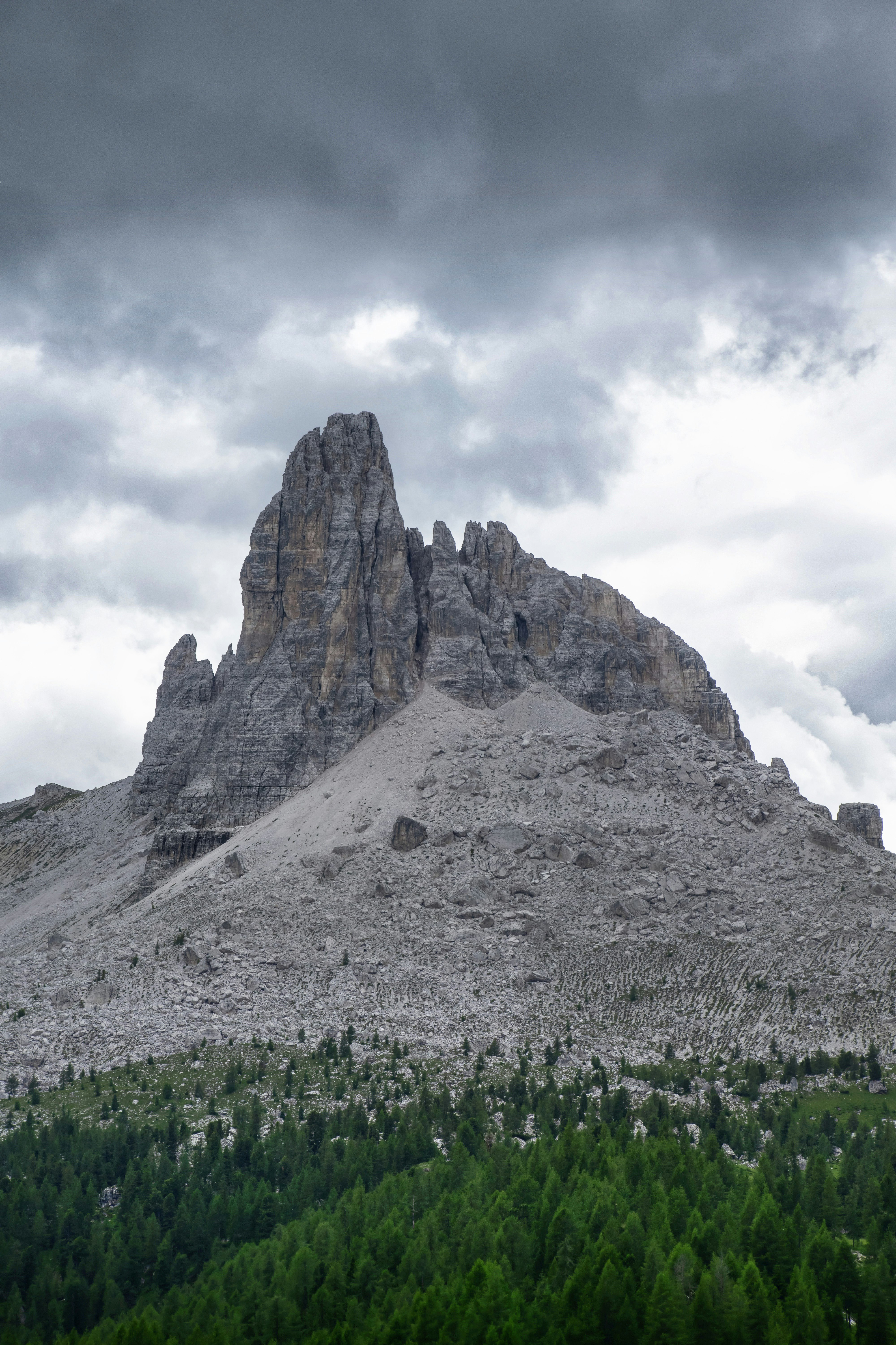 gray rocky mountain under white cloudy sky during daytime