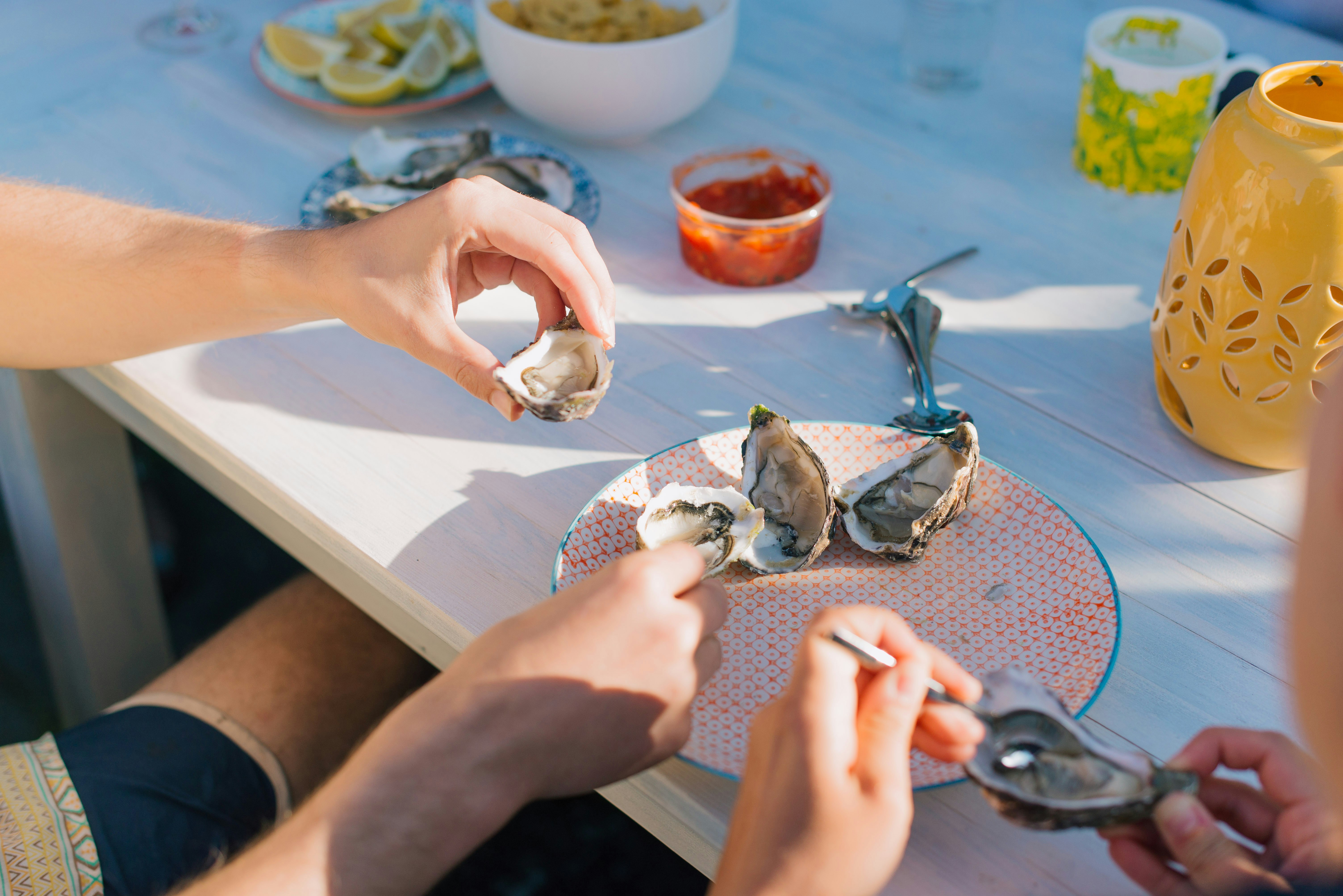 person holding a silver fish on a table