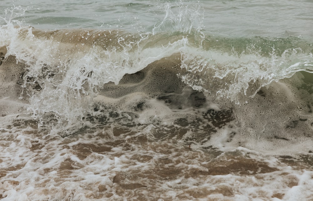 ocean waves crashing on shore during daytime