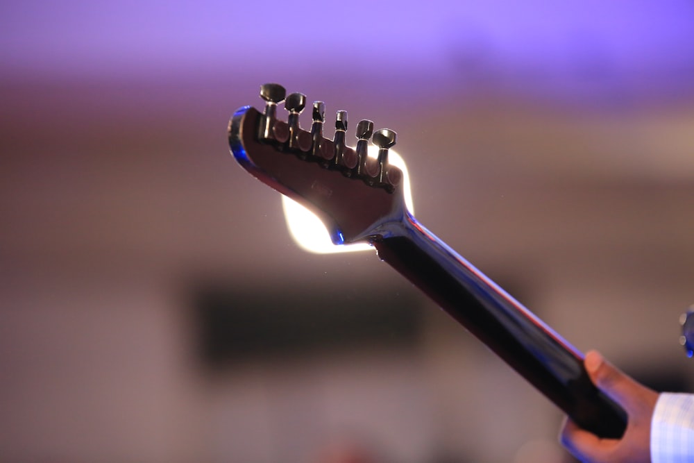 black guitar pick in close up photography