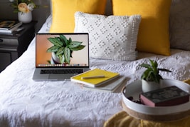 macbook pro on white bed