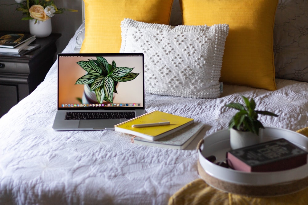 macbook pro on white bed