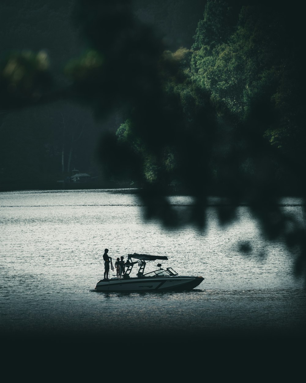 people riding on boat on lake during daytime