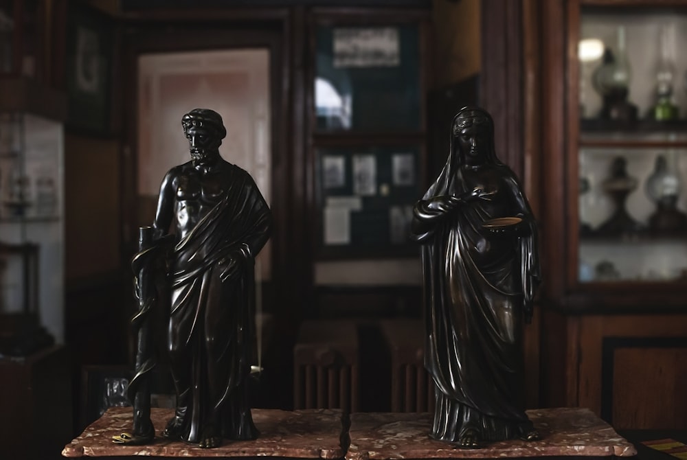 black statue of man and woman