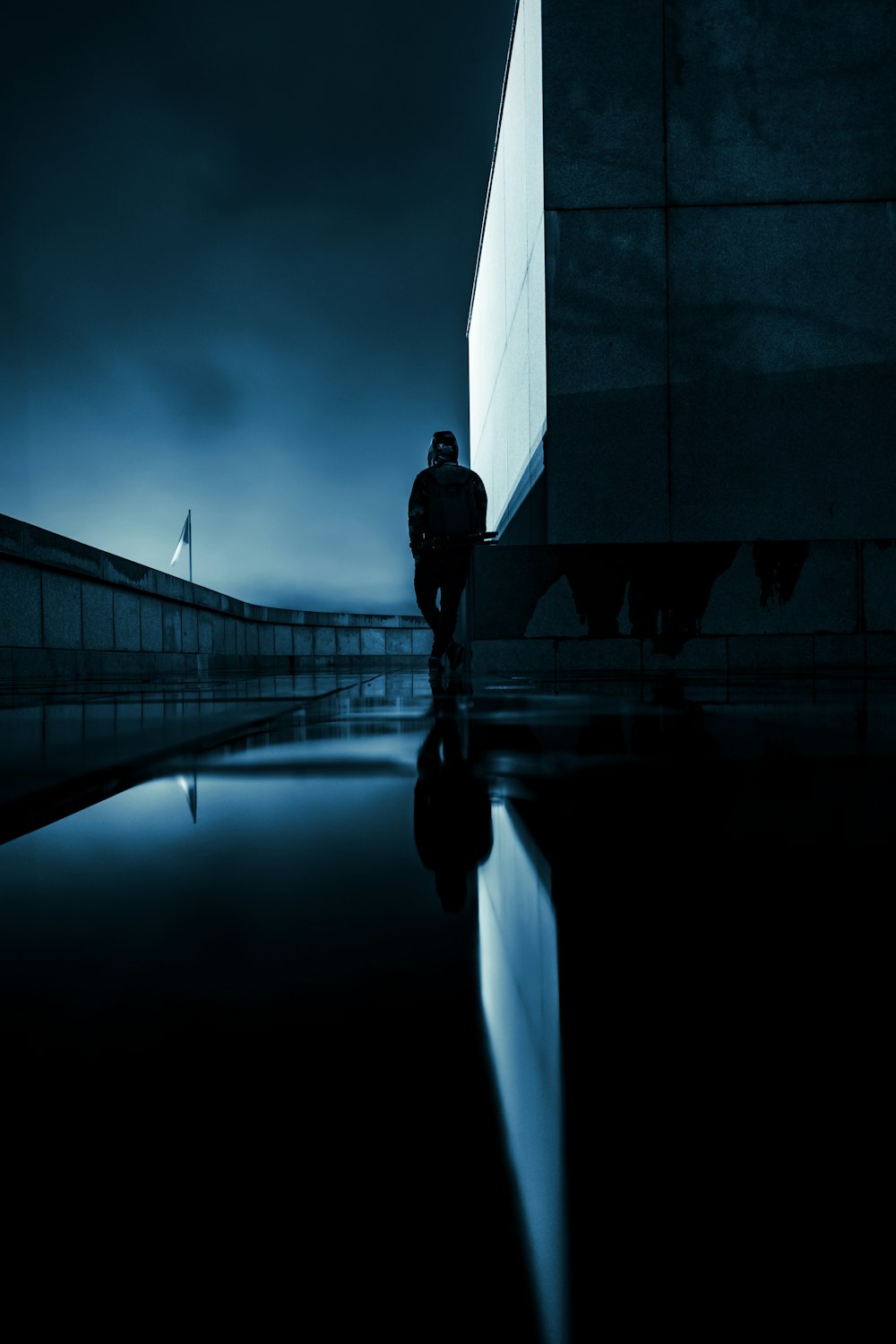 man in black jacket standing on bridge