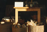 A rustic wooden table displaying a variety of tilted barn coffee boxes in natural light.