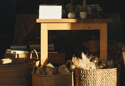 Stacks of ancient olaichuvadis neatly arranged on a wooden table, bathed in soft sunlight.