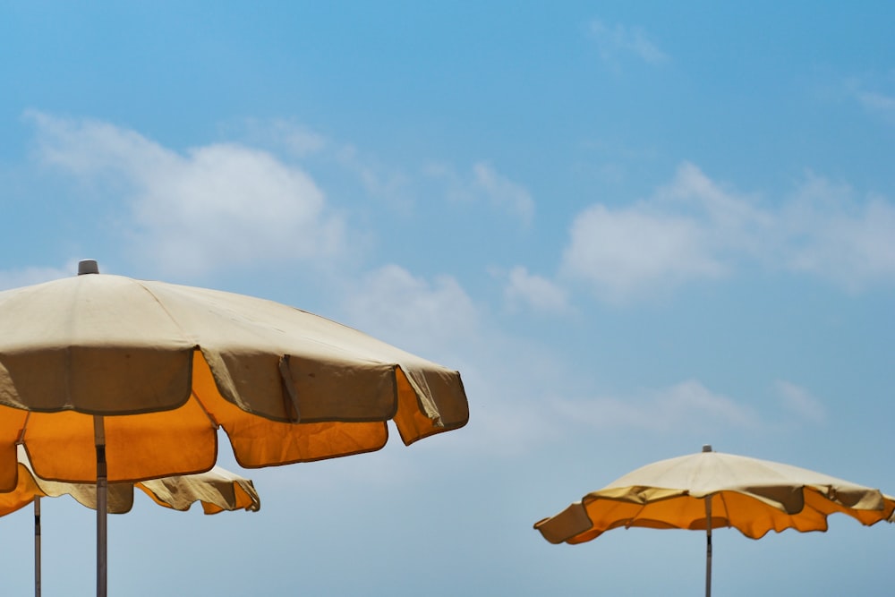 white and yellow umbrella under blue sky during daytime