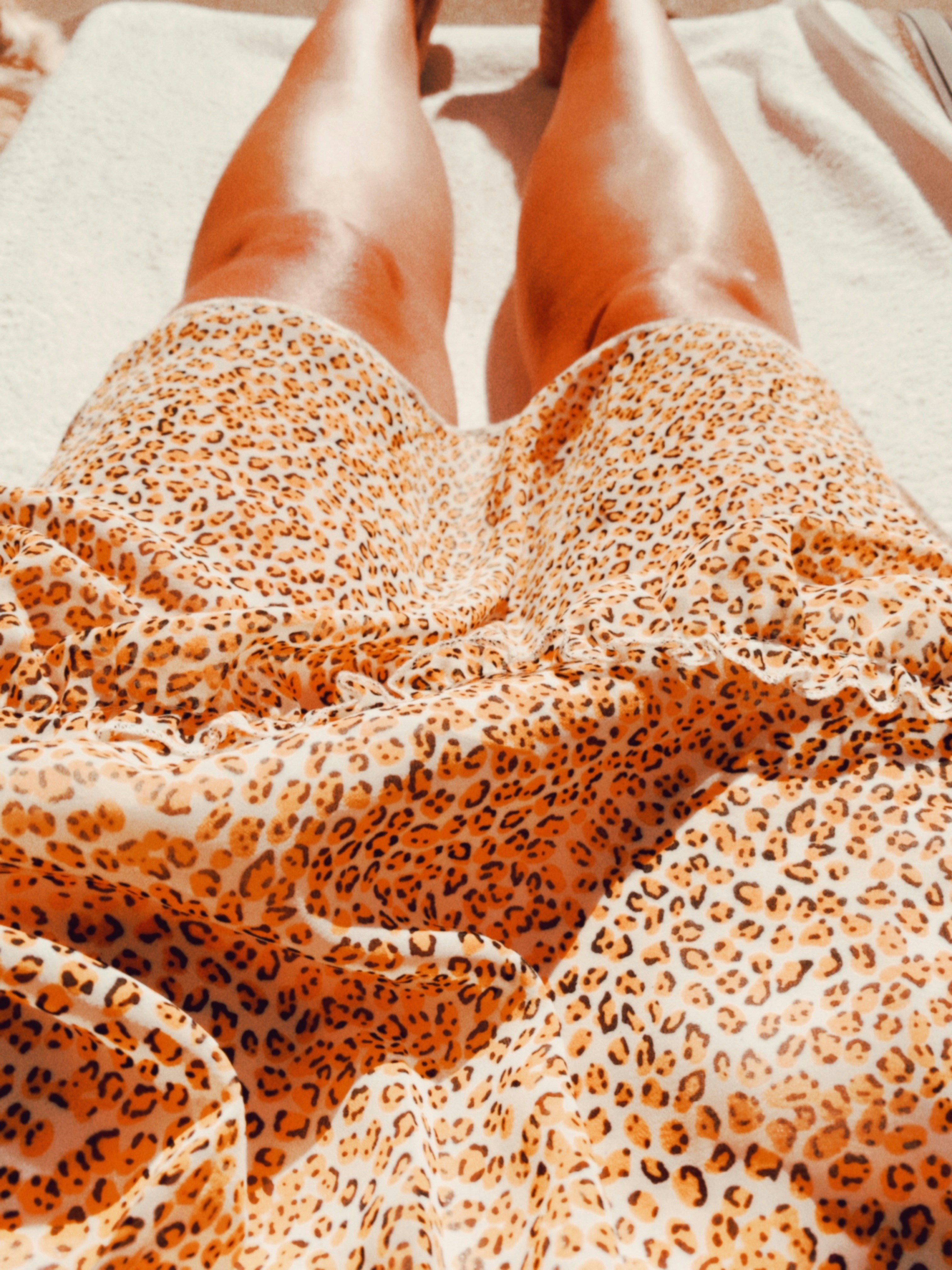 person in brown and white leopard print pants