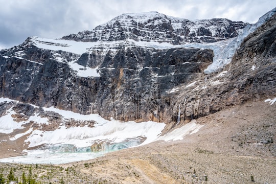 snow covered mountain under cloudy sky during daytime in Mount Edith Cavell Canada