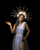 Beaded waist chain cinching a flowing dress, perfect for festival vibes.