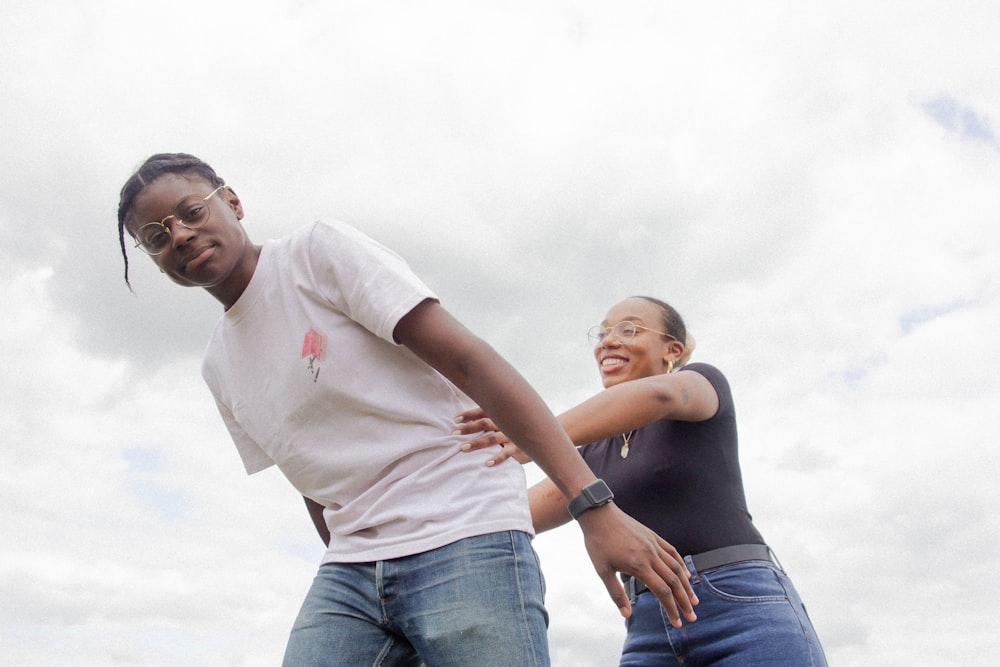 woman in white t-shirt and woman in blue denim jeans