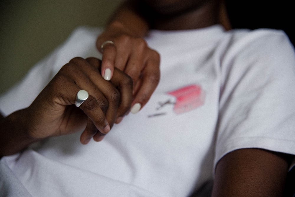 person holding hands with silver ring