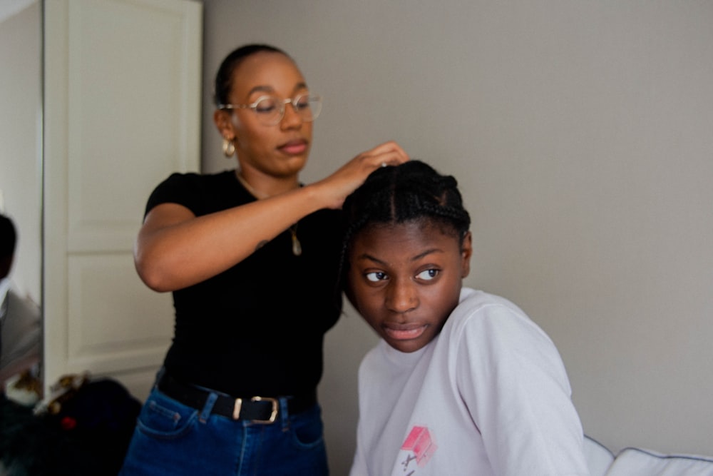 woman in black crew neck t-shirt and blue denim jeans