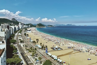 people on beach during daytime In Copacabana Beach, Rio de Janiero, Brazil