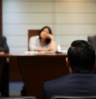 man in black shirt sitting beside woman in white shirt