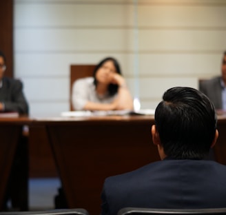 man in black shirt sitting beside woman in white shirt