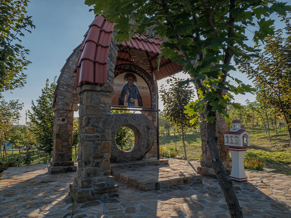 brown brick arch with green trees