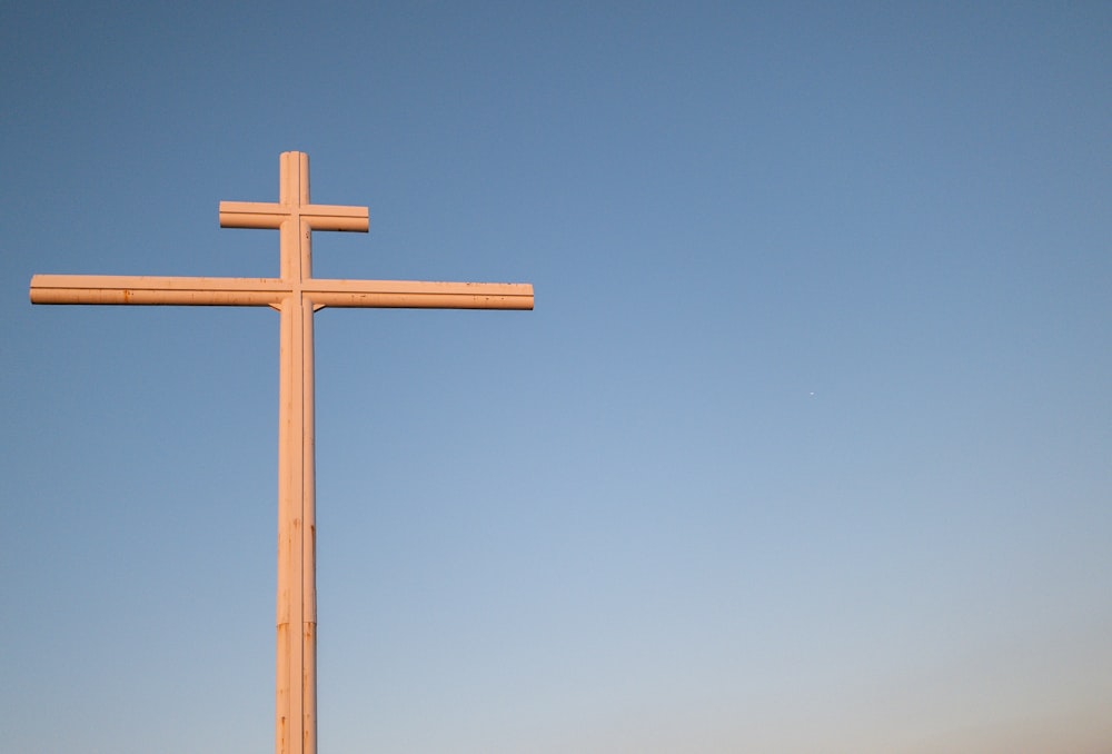 brown wooden cross under blue sky during daytime