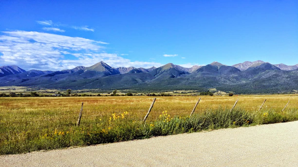 A warm Montana ranch landscape under open skies with a family discussing plans outdoors.