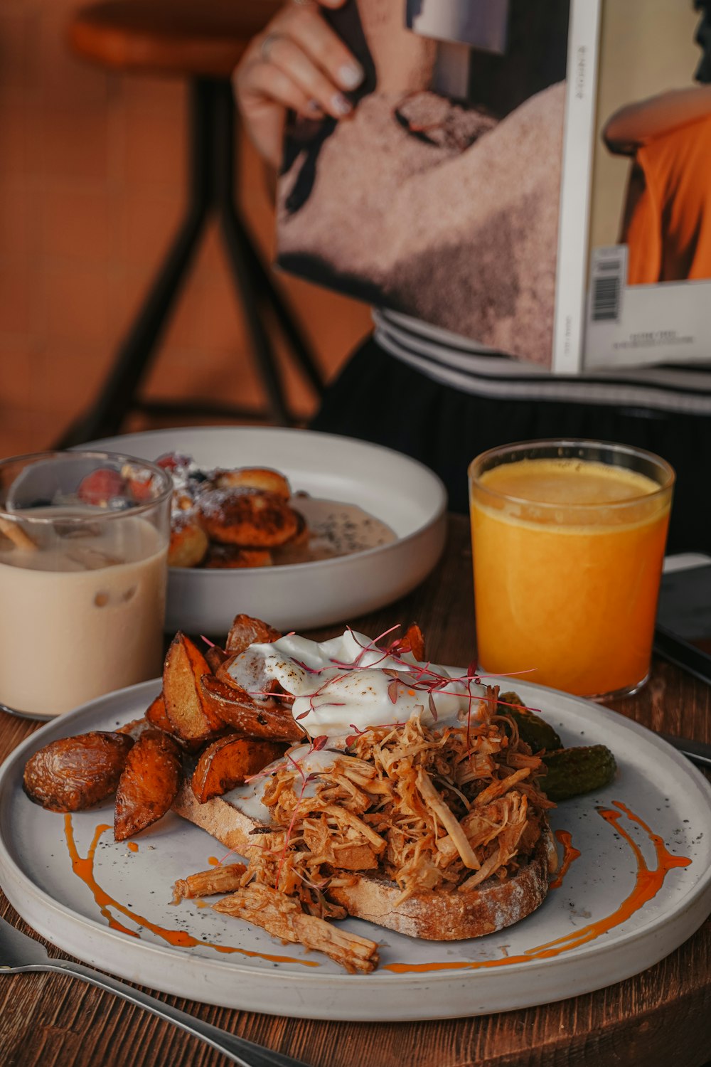 cooked food on white ceramic plate beside clear drinking glass with yellow liquid