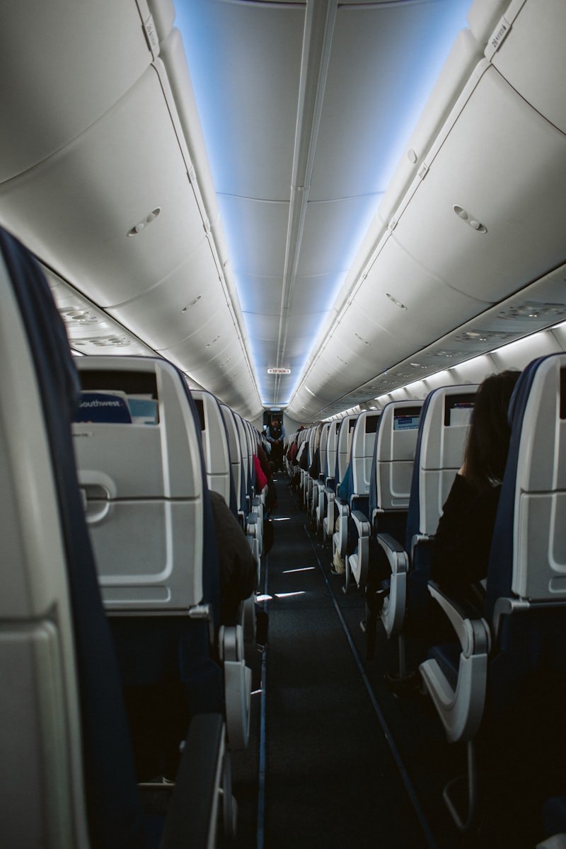 Airplane cabin during long-haul flight where compression socks prevent DVT and reduce leg swelling for travelers