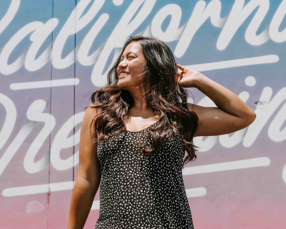 woman in black and white polka dots tank top