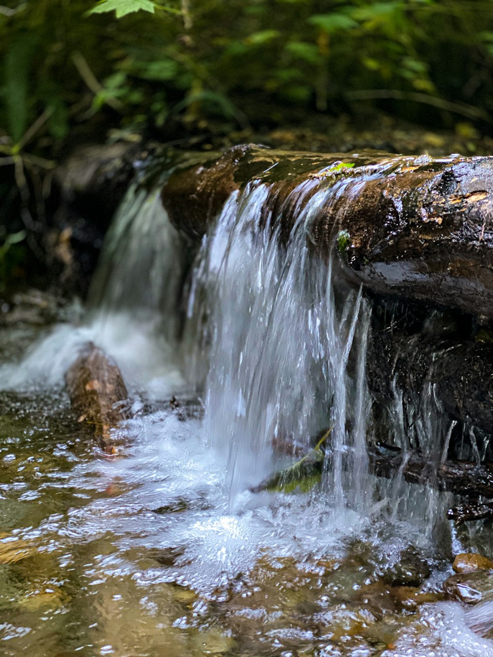 water falls on brown rock