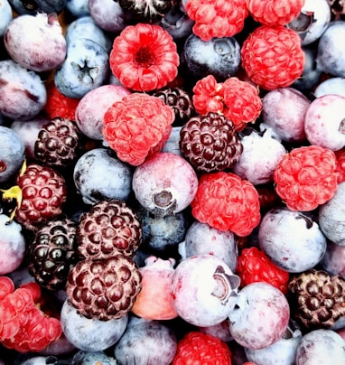 red and black berries on black surface