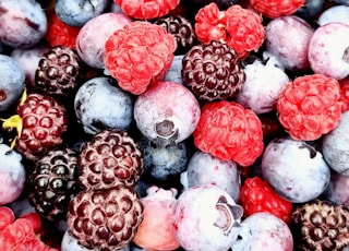 red and black berries on black surface