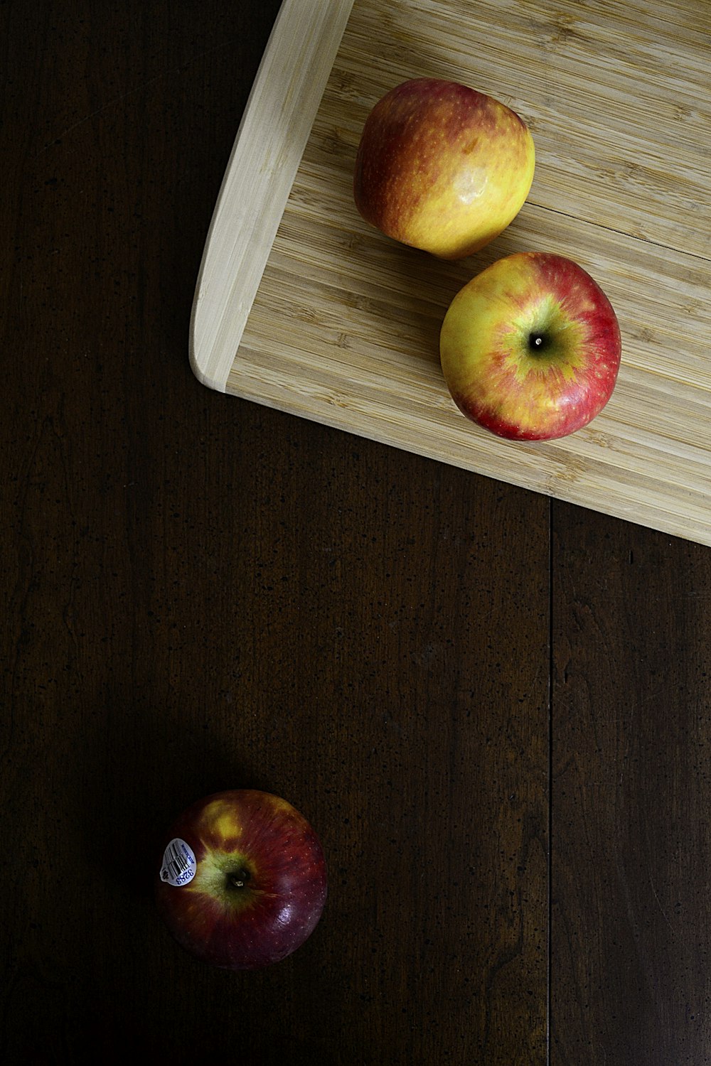 red and yellow apple fruit on brown wooden table