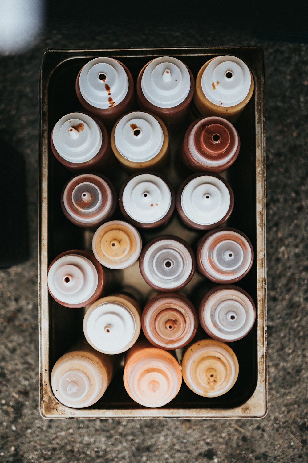 white and brown round plastic containers