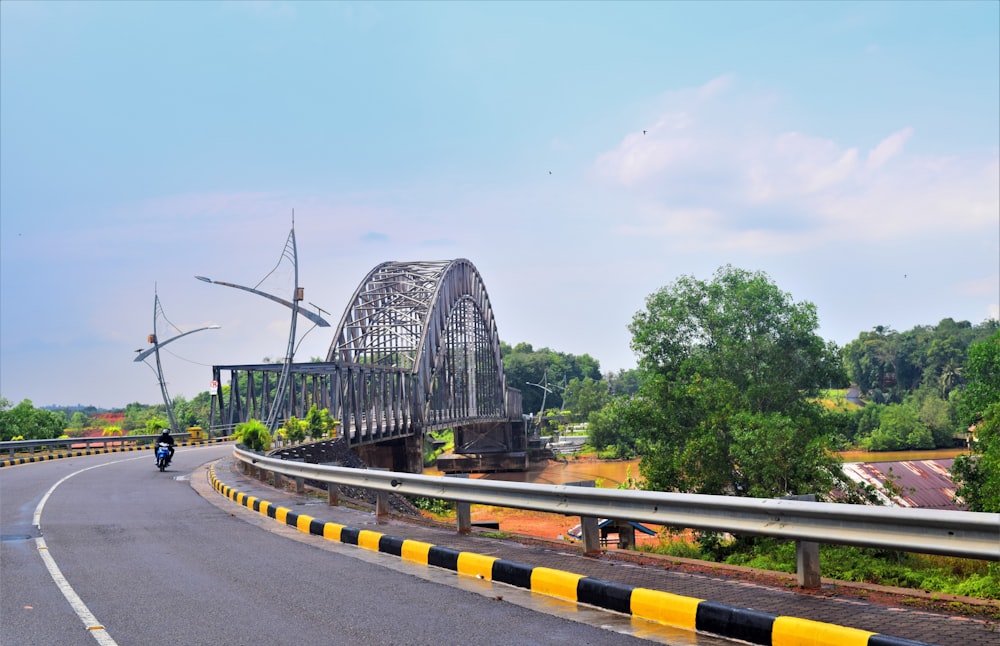 gray concrete bridge under blue sky during daytime