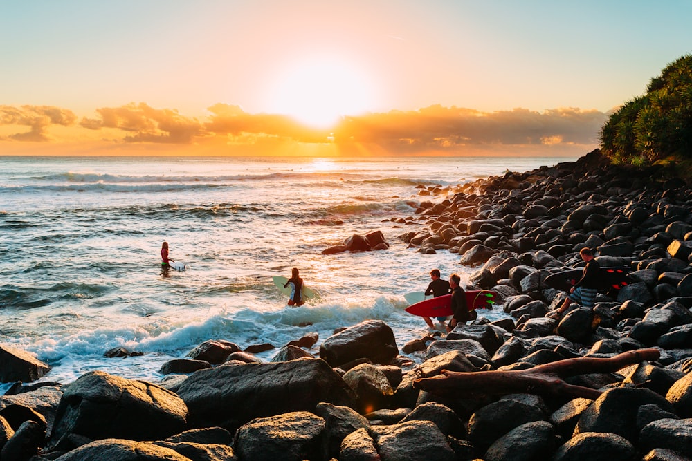 people on beach during sunset