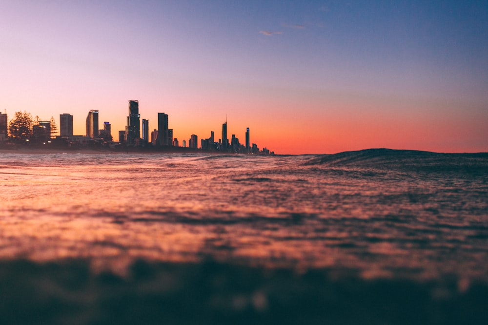 silhouette of city buildings during sunset