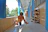Happy toddler playing with a caring doctor in a bright, welcoming hospital hallway.