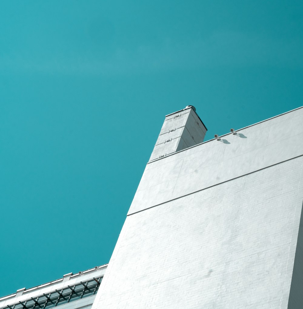 Graues Betongebäude unter blauem Himmel tagsüber