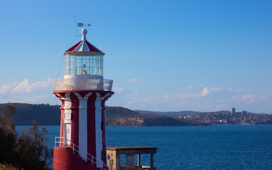 white and red lighthouse near body of water during daytime in Hornby Lighthouse Australia