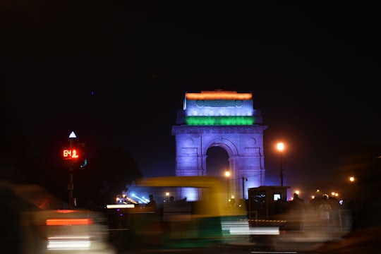 white concrete arch during night time in India Gate India